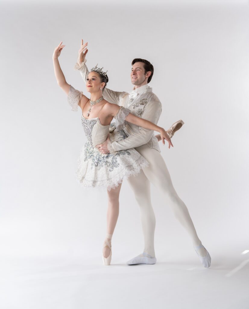 Ballet dancers in an elegant pose wearing elaborate costumes, possibly related to Sleeping Beauty ballet.